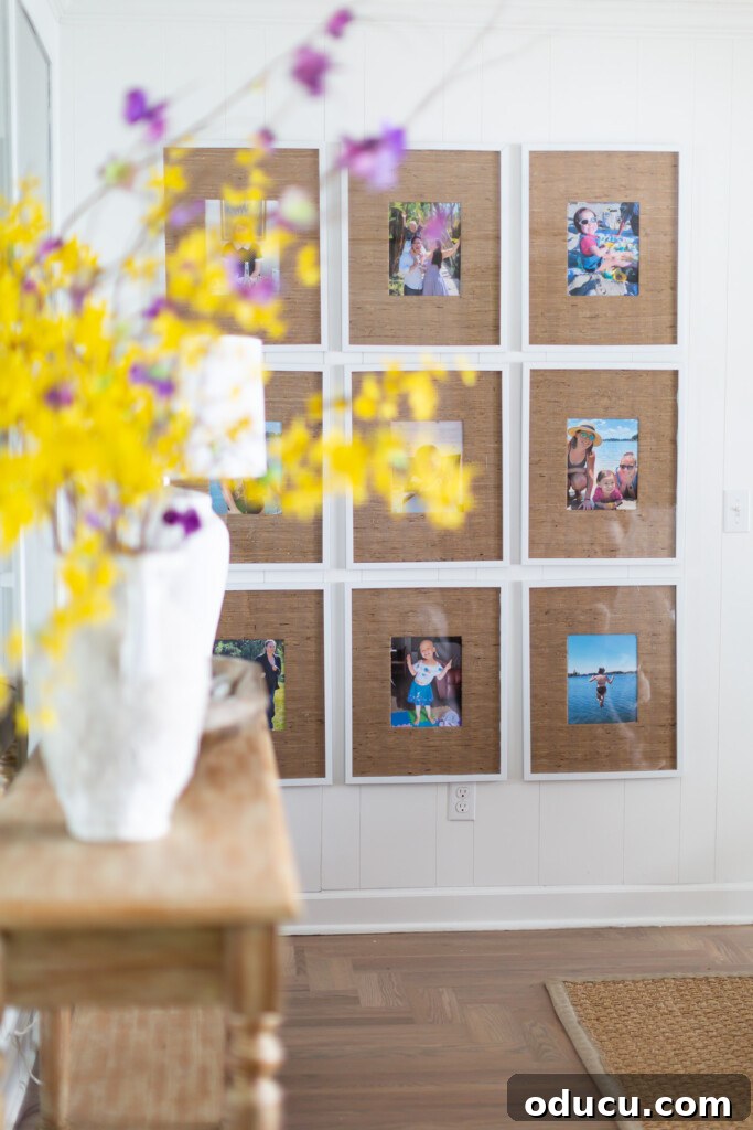 The Evolution of My Living Room Style 36 9 grid gallery wall in living room with grasscloth wallpaper remnant photo frame mats.