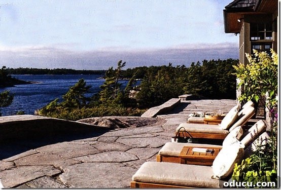 Uncover Your Personal Decorating Style 4 Stone patio overlooking a wide body of water, capturing a serene view.
