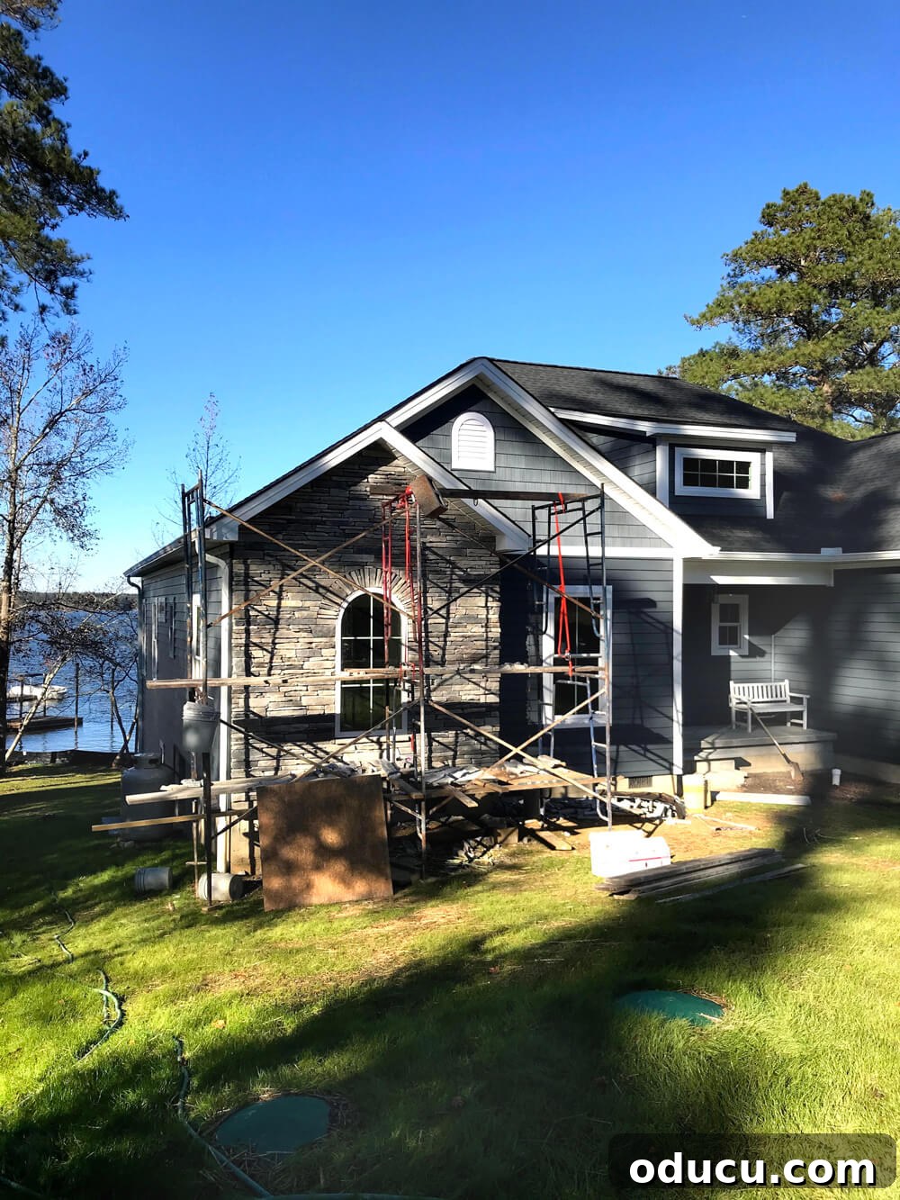 My Love Affair with Resilient Flooring Understanding Its Enduring Appeal 3 Front exterior of house being built on shores of a lake.