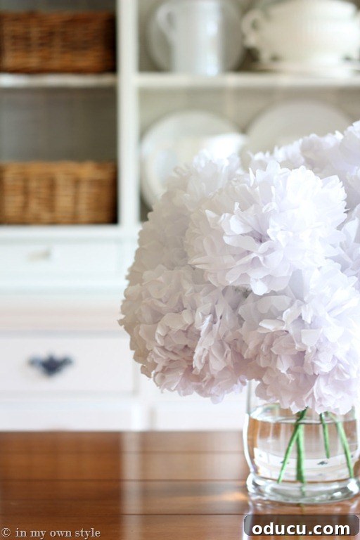 Instant Spring Flowers: No Blooms Required 5 Close up of tissue paper flowers in glass vase on dining table.