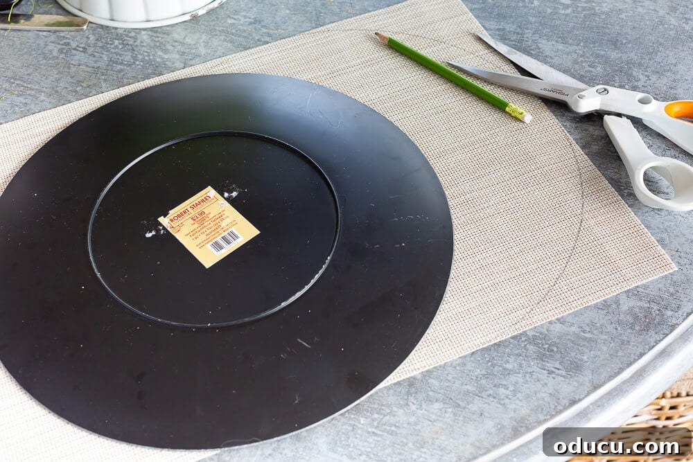 Showing how to trace around a large plate on a rectangular placemat to make a round placemat.