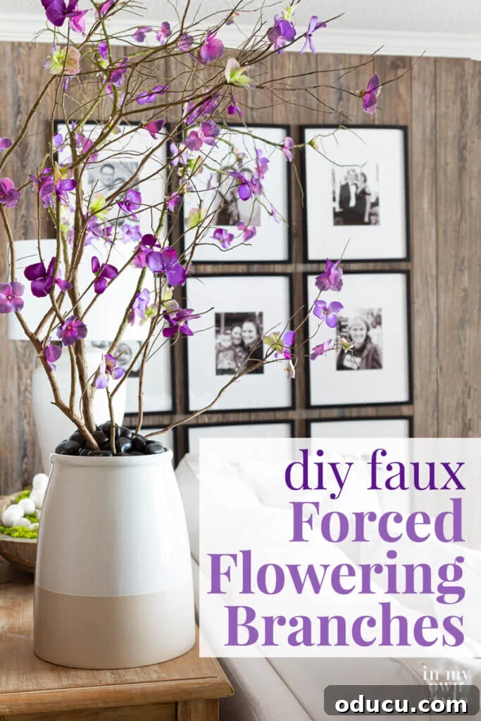 DIY Everlasting Floral Branches 12 Faux blooming branches in large planter behind a sofa