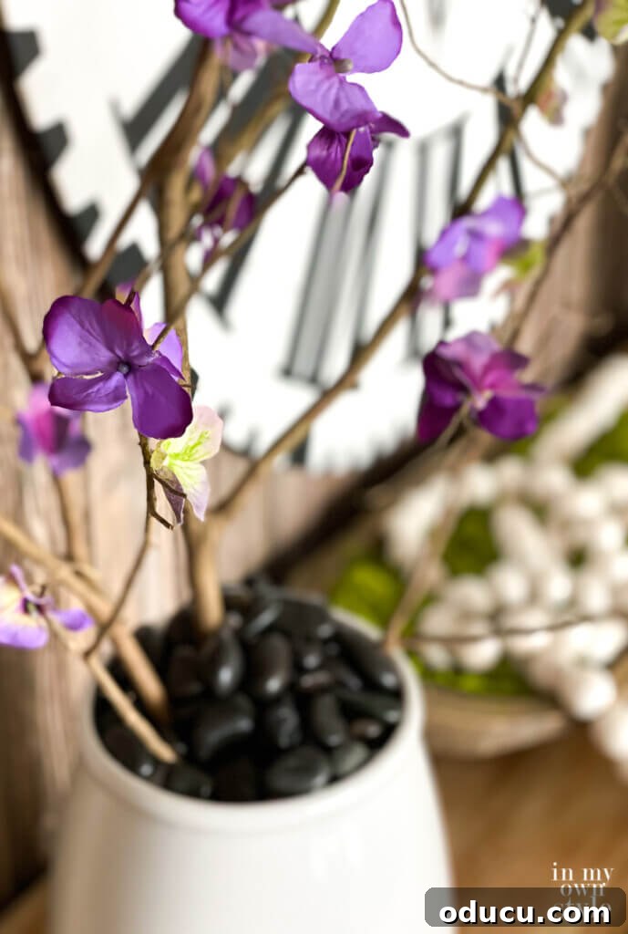 DIY Everlasting Floral Branches 5 Looking across a console table decorated for spring with faux forced flowering branches.