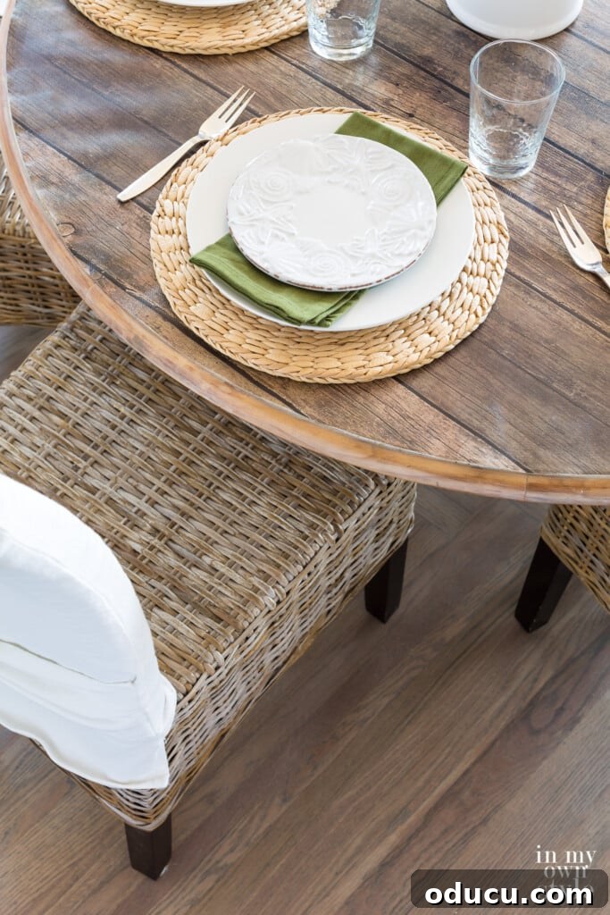 Style Intel: Volume 37 3 Elegant birds-eye view of a kitchen table setting, beautifully arranged with elements in driftwood grey, crisp white, and refreshing green tones, perfect for summer dining.