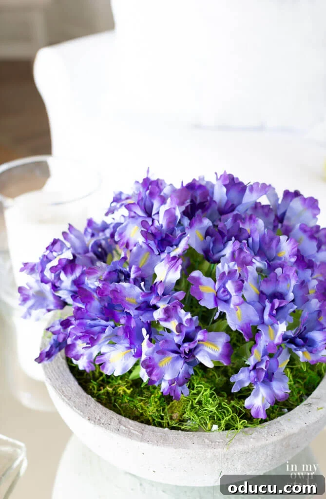Pretty purple flowers in large bowl on coffee table.