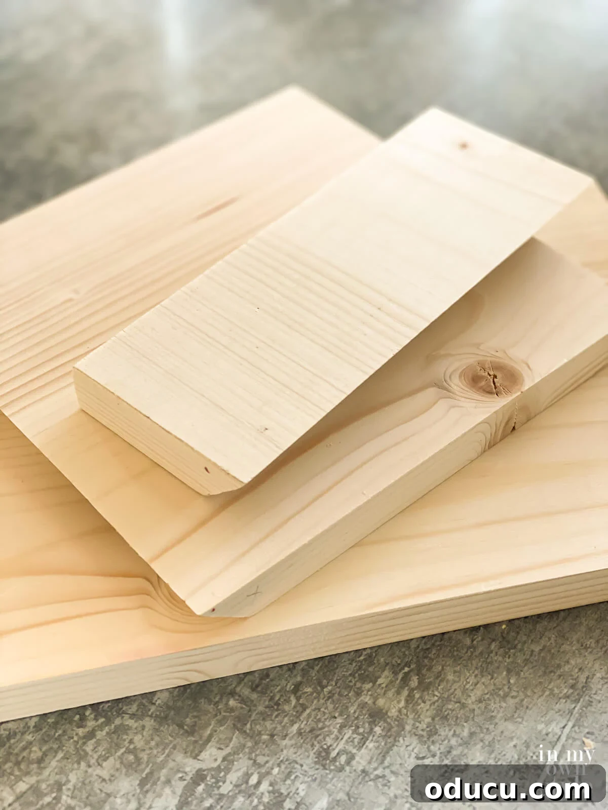 Scrap wood cut into pieces needed to make a x shape book stand for a table.