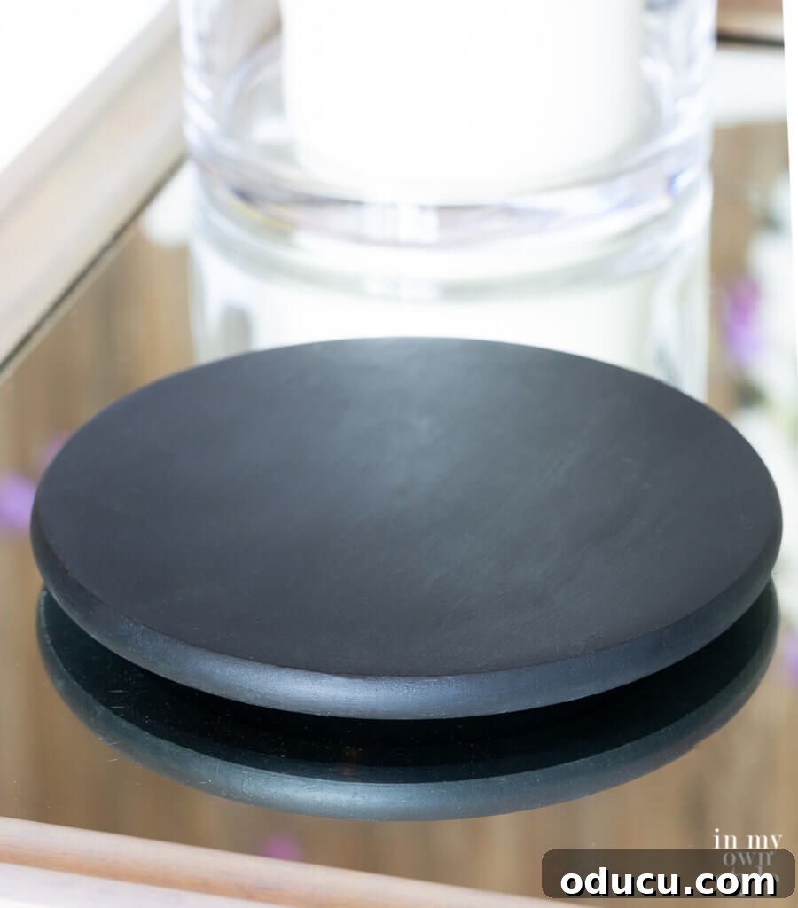 black painted wood turntable to hold x shaped open book stand.