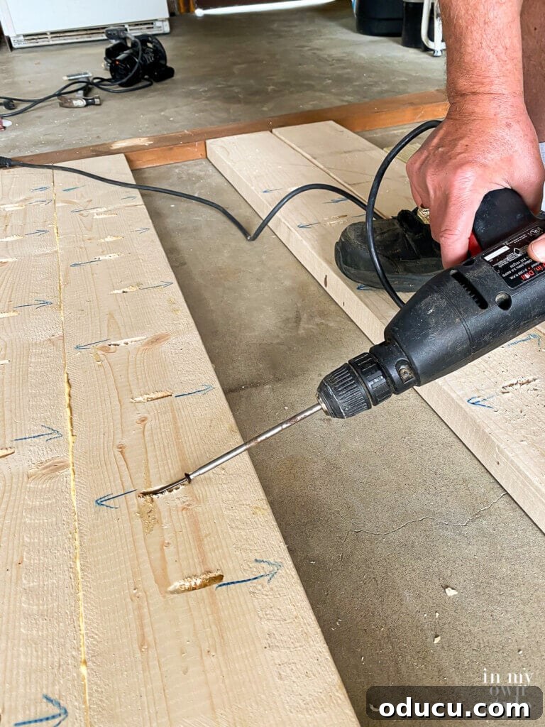 Crafting a Custom Round Wood Kitchen Tabletop 16 Adding wood screws into pocket holes on under side of wood boards.