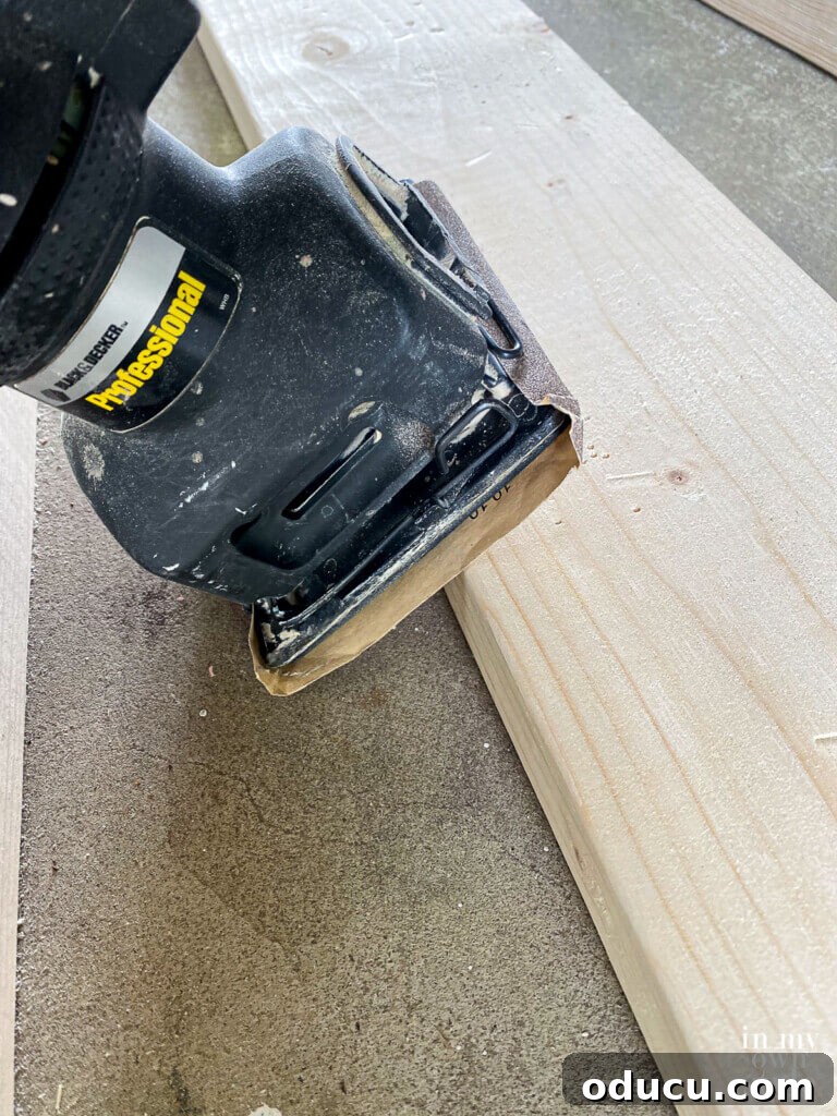 Crafting a Custom Round Wood Kitchen Tabletop 9 Sanding edge of each pine board before assembling table.