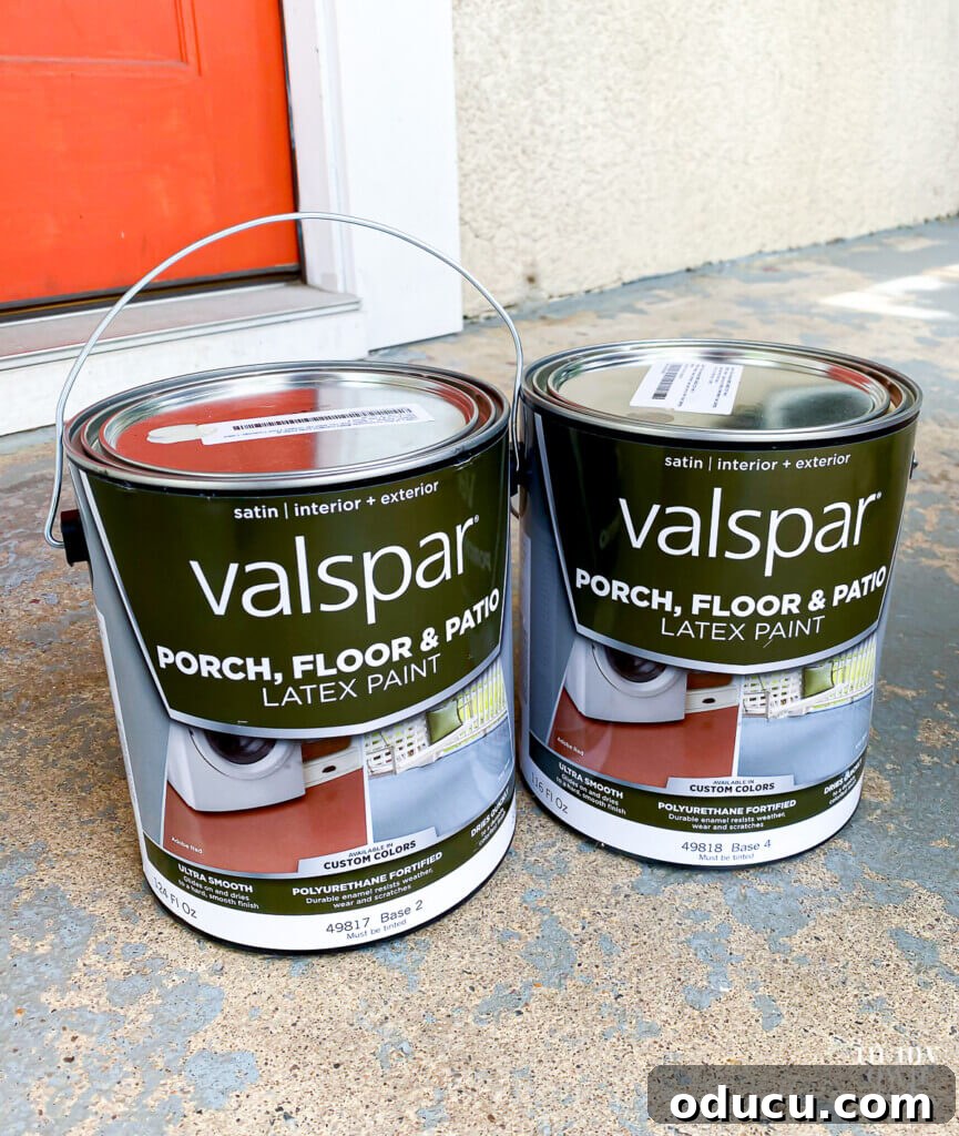 Beton Veranda ve Teras Boyama ve Şablonlama Rehberi 4 Valspar Porch Floor and Patio Latex Paint Gallons sitting on worn porch floor, ready for use