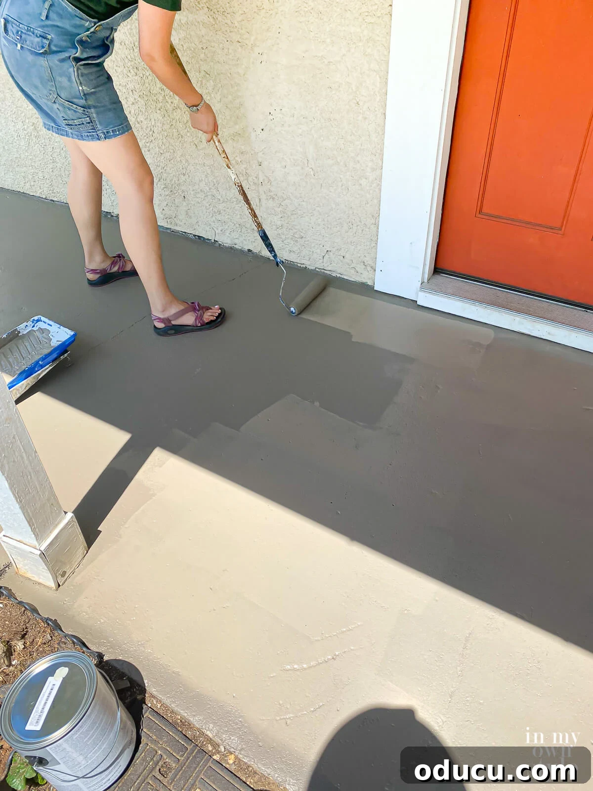 Transform Your Concrete Porch or Patio with Paint and Stencils 8 How to paint a concrete porch floor using a paint roller on a pole.