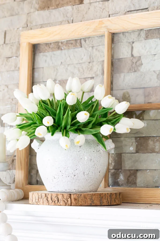 Elegant summer themed mantel featuring a refreshing white and green color palette, perfect for modern farmhouse decor.