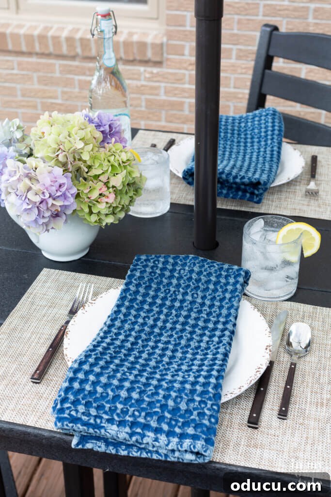 Transforming My Deck with POLYWOOD Outdoor Furniture 17 A sophisticated black POLYWOOD bar height table set on a deck, perfectly arranged for elegant alfresco dining.