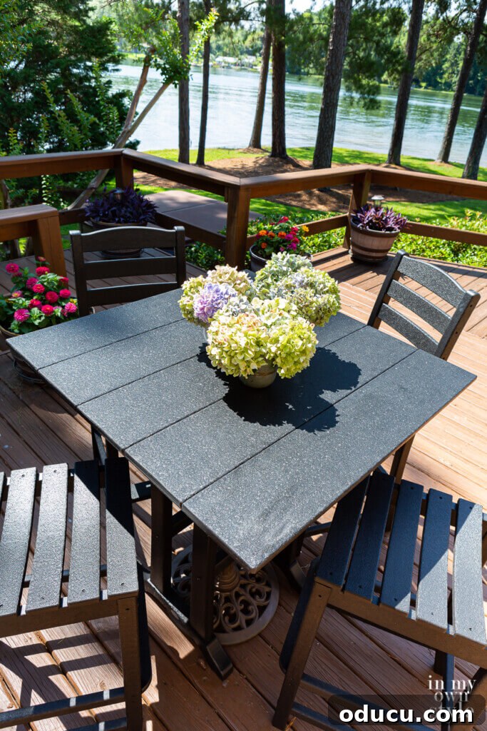 Transforming My Deck with POLYWOOD Outdoor Furniture 8 An inviting aerial view of a black POLYWOOD La Casa Cafe Farmhouse Trestle Bar set on a backyard deck, showcasing an ideal setup for outdoor entertaining and parties.