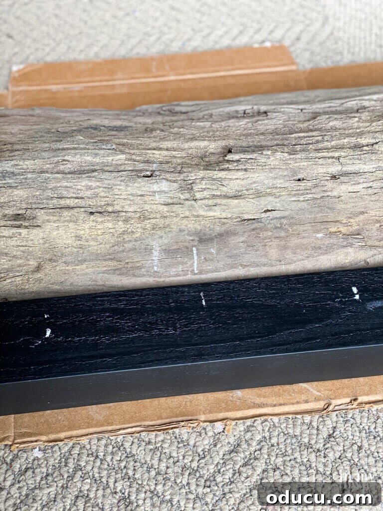 Craft a Natural Driftwood Art Display 11 Marking the center of the wood pieces with chalk to ensure precise drilling for the dowel holes.