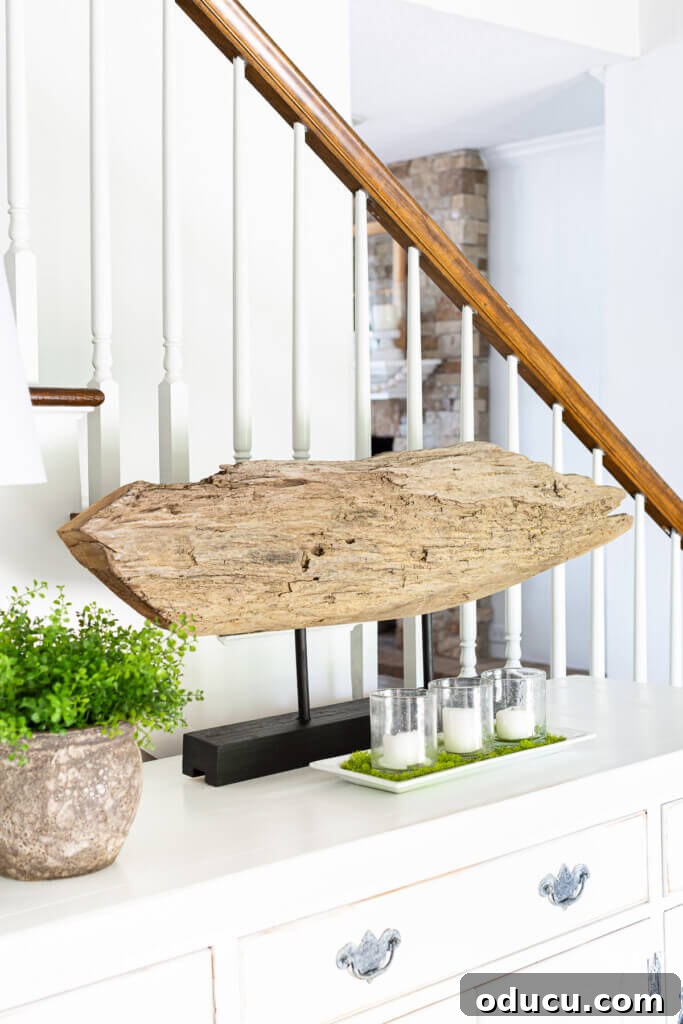 Craft a Natural Driftwood Art Display 18 DIY modern wood slab art displayed on a sideboard, beautifully styled with candles for a serene home atmosphere.