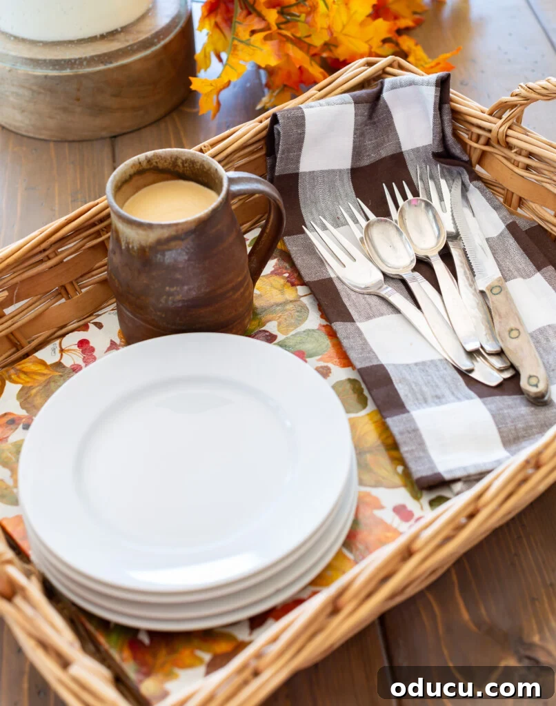 Crafting Versatile Serving Trays for Every Occasion 2 Wicker basket tray completed with autumn leave pattern paper, holding white plates, a brown and white napkin, and a rustic mug, showcasing a stable and decorative surface.
