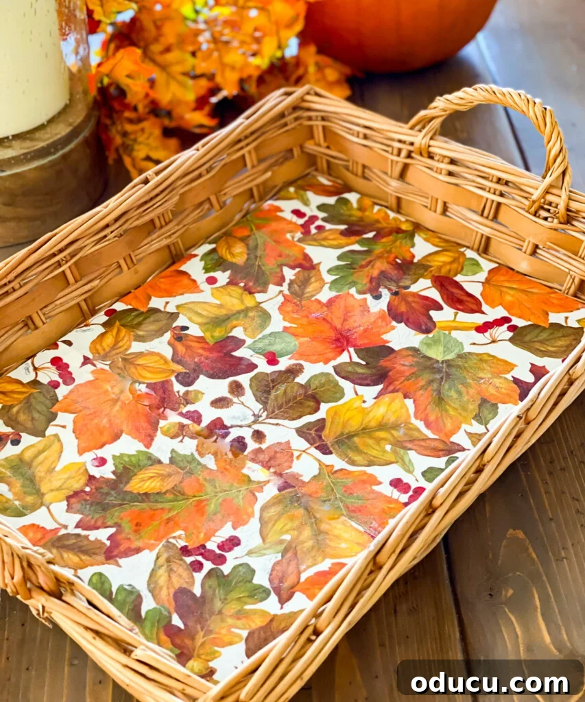Crafting Versatile Serving Trays for Every Occasion 18 Fall leave napkins lining a wicker basket tray, demonstrating the finished product of a vinylized insert.