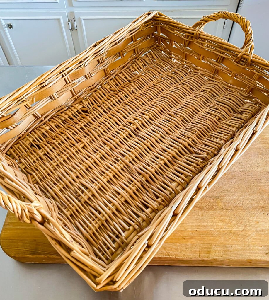 Crafting Versatile Serving Trays for Every Occasion 3 Empty wicker tray basket on a clean kitchen counter, ready for a decorative insert.