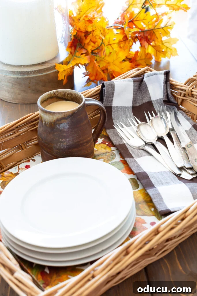 Crafting Versatile Serving Trays for Every Occasion 5 Wicker basket tray completed with autumn leave pattern paper. White plates and brown and white napkin and rustic mug.