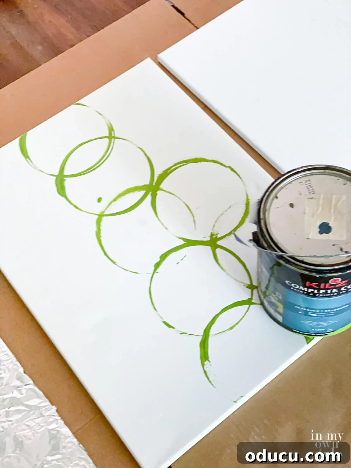 How to make modern art on canvas using the bottom of a gallon paint can.