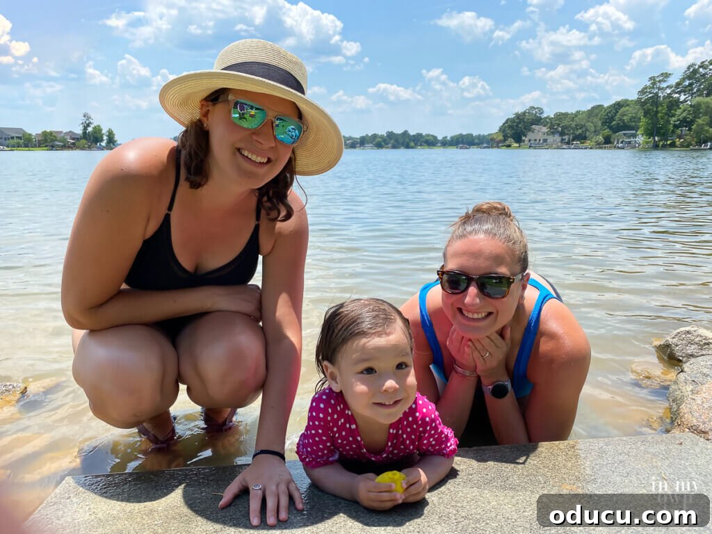 Style Scouting Forty Seven 3 Two daughters smiling by the shimmering lakeshore, enjoying their family vacation.