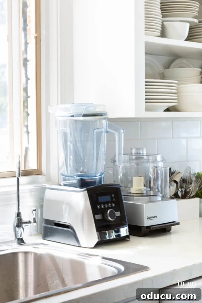 Kitchen Counter Harmony: Blending Function and Style 6 Vitamix blender and Cuisinart Food Processor on a kitchen counter.