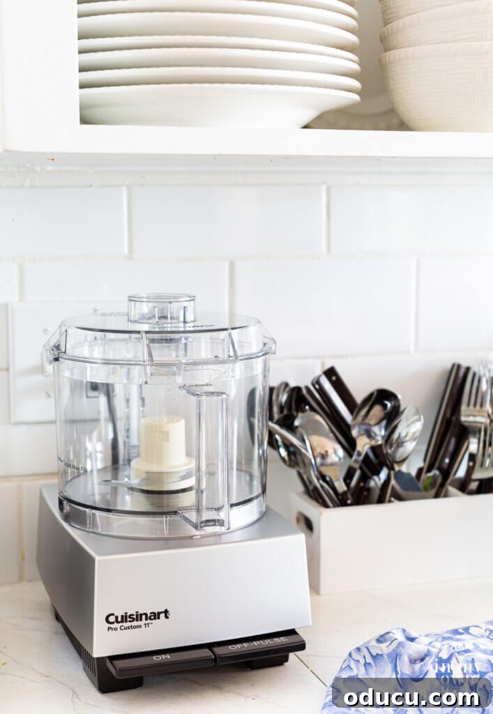 Kitchen Counter Harmony: Blending Function and Style 7 Kitchen countertop appliance organization Cuisinart Pro Custom 11 Food Processor on a counter in a small kitchen.