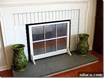 Repurposed window sash transformed into a stylish fireplace firebox cover, effectively concealing the dirty interior.