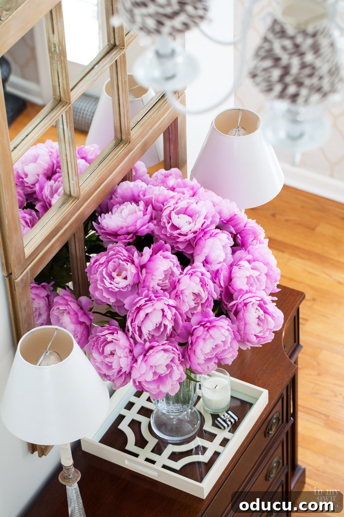 Elegant foyer decor featuring a large decorative mirror crafted from old window frames, enhancing the entryway.