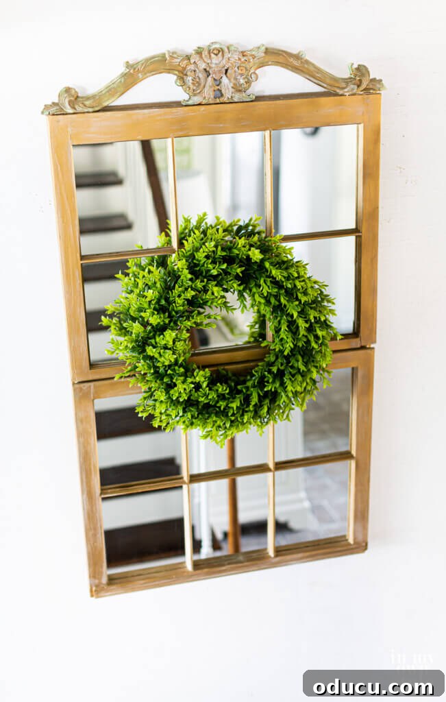 Decorative mirror made from two repurposed old wood window frames with muntins, adding a rustic touch to home decor.