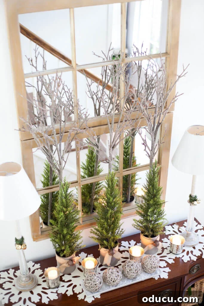 Festive foyer decorated for Christmas, featuring a large mirror made from two old wood window frames as a central piece.