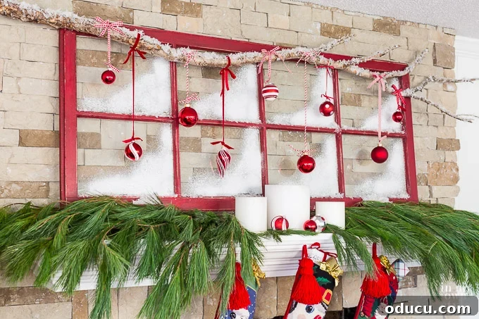 Muntin glass and wood window sash painted red, repurposed as festive Christmas decor on a fireplace mantel.