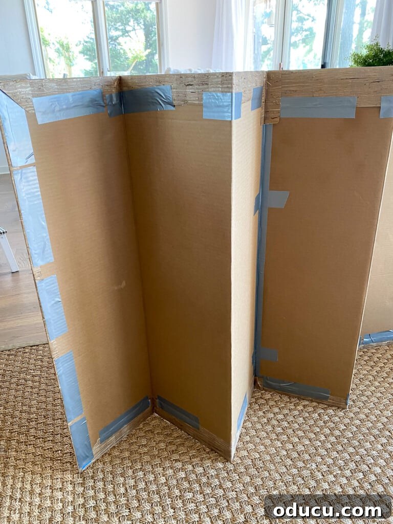 DIY Fireplace Cover Seamlessly Built 14 How to attach wallpaper securely to a cardboard fireplace cover using tape.