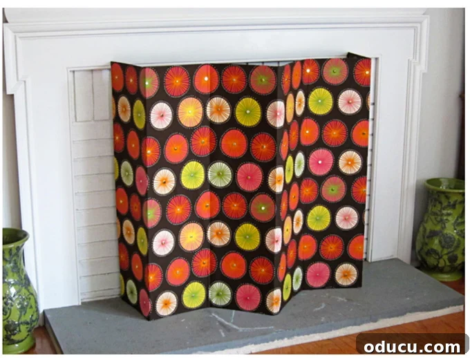 DIY Fireplace Cover Seamlessly Built 9 Completed 6-panel fabric covered fireplace screen with a decorative pattern.