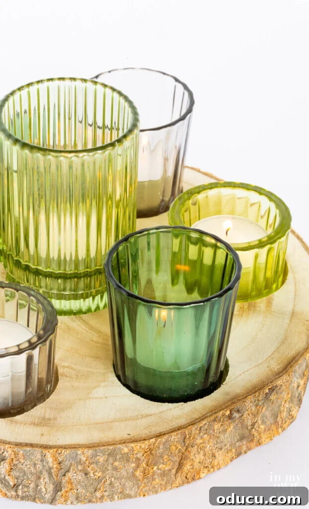 Woodland Inspired DIY Tealight Holders 3 Close up of green glass candle votives in a rustic wood slice.