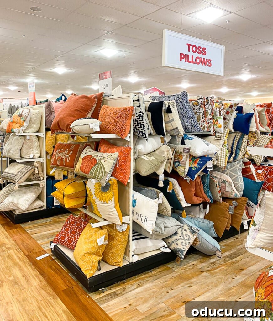 Instant Home Updates with Throw Pillow Covers 2 A vibrant display of toss pillows for sale, showcasing various colors and textures, at a home goods store.
