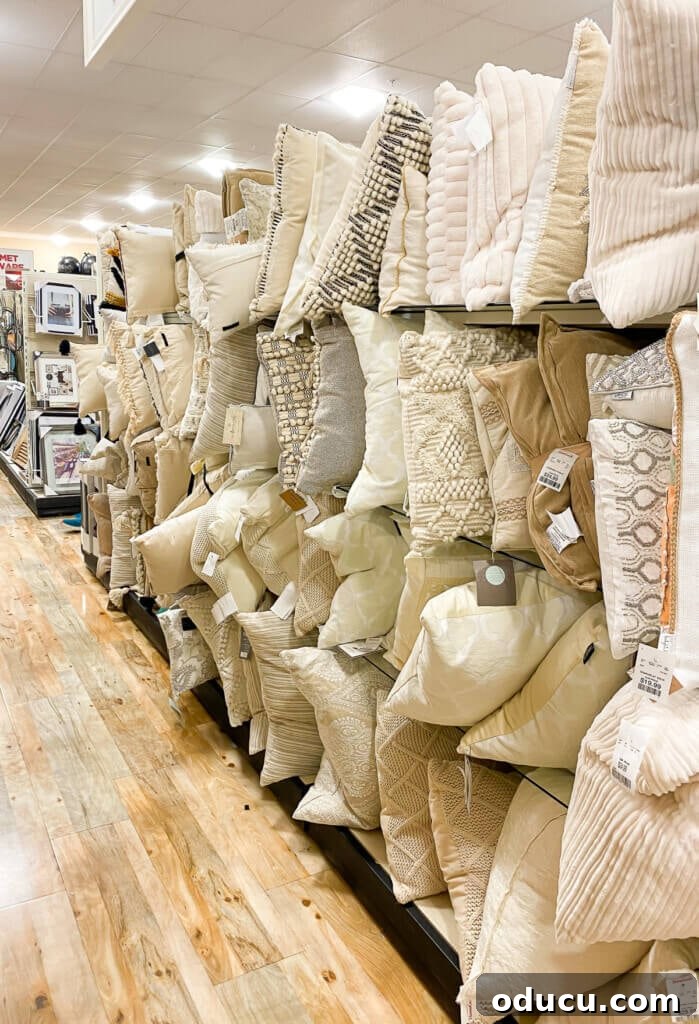 Instant Home Updates with Throw Pillow Covers 4 A display of neutral-colored throw pillows, highlighting subtle textures and understated elegance, at a home goods store.
