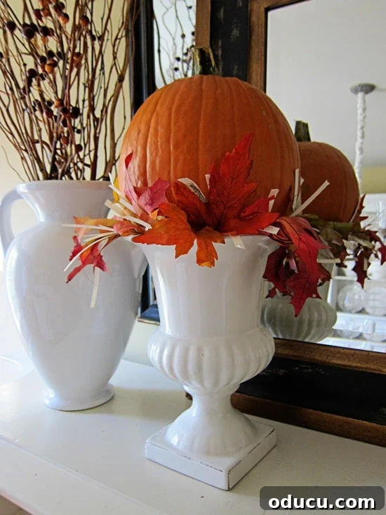 Cozy Autumn Vases: Effortless Ideas for a Warm Home 15 A white urn make into a fall pumpkin vase.