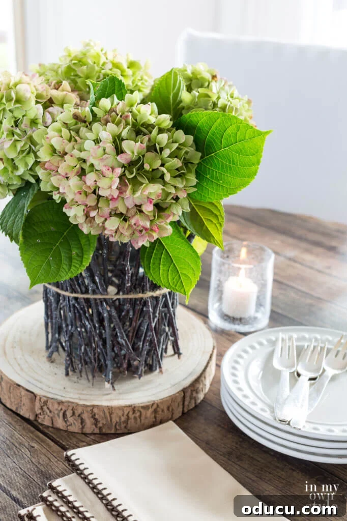 Cozy Autumn Vases: Effortless Ideas for a Warm Home 3 Dining table fall centerpiece. Tree twig vase with dried hydrangeas.