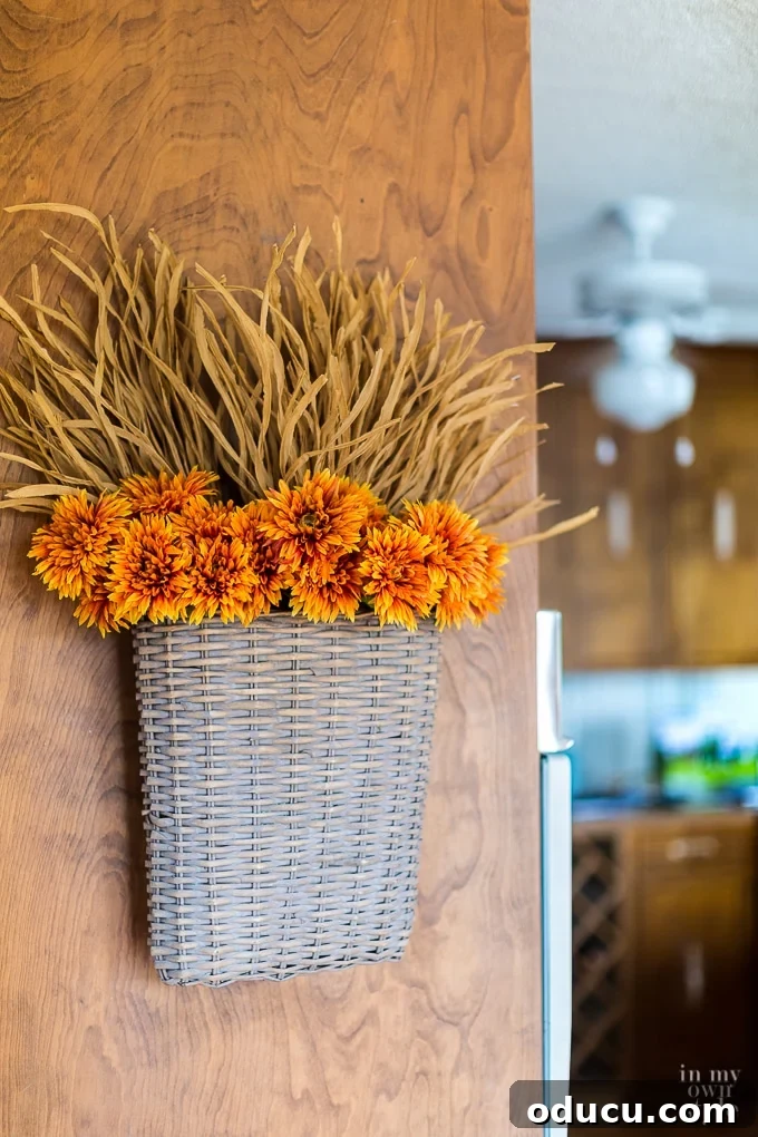 Cozy Autumn Vases: Effortless Ideas for a Warm Home 6 a hanging basket filled with dried fall flowers used in place of a vase.