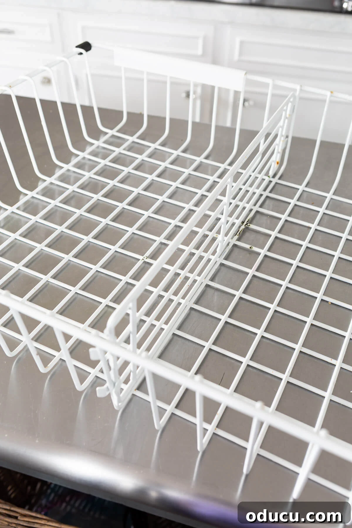 DIY Freezer Drawer Organization Hacks 7 White coated wire Freezer drawer basket on table.
