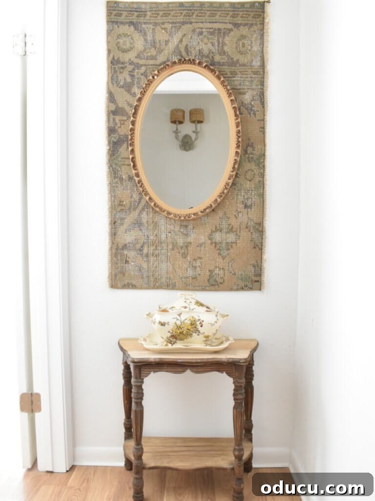 Style Dossier 62 2 A charming small hallway with a decorative mirror and natural elements.