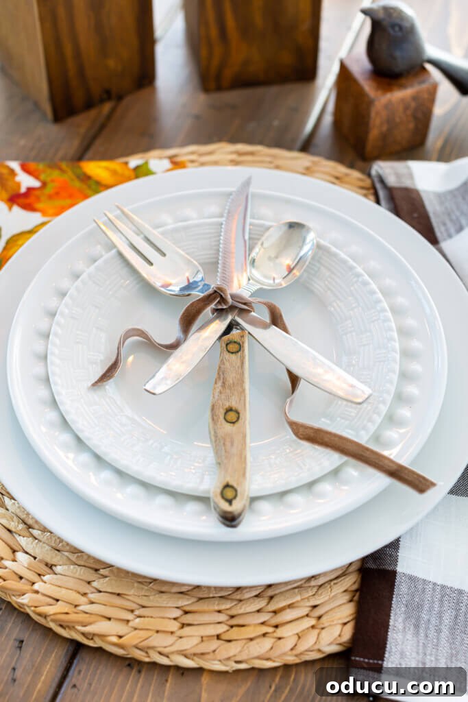 Transform Wood Scraps Into Beautiful Candle Holders Easily 3 Table place setting of a white dinner plate layered with a fork, knife and spoon tied with brown ribbon.