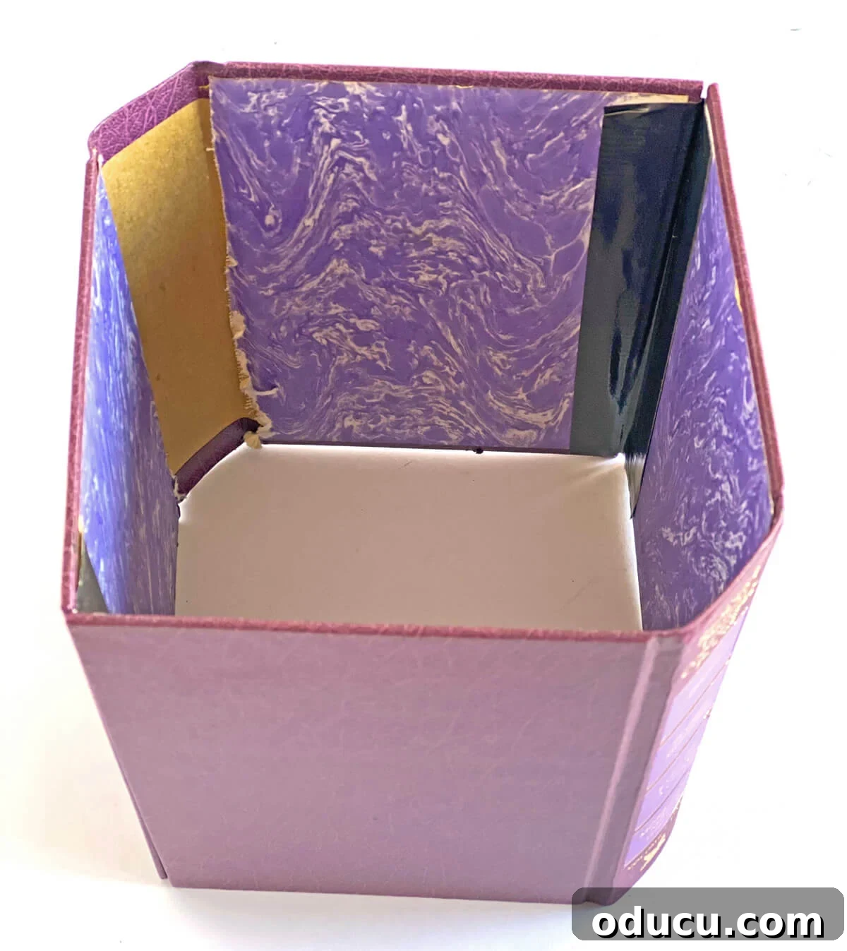 Literary Planters: Crafting Covers from Old Books 13 Finished decorative cover made from two books taped together, ready to be placed over a plastic planter pot.