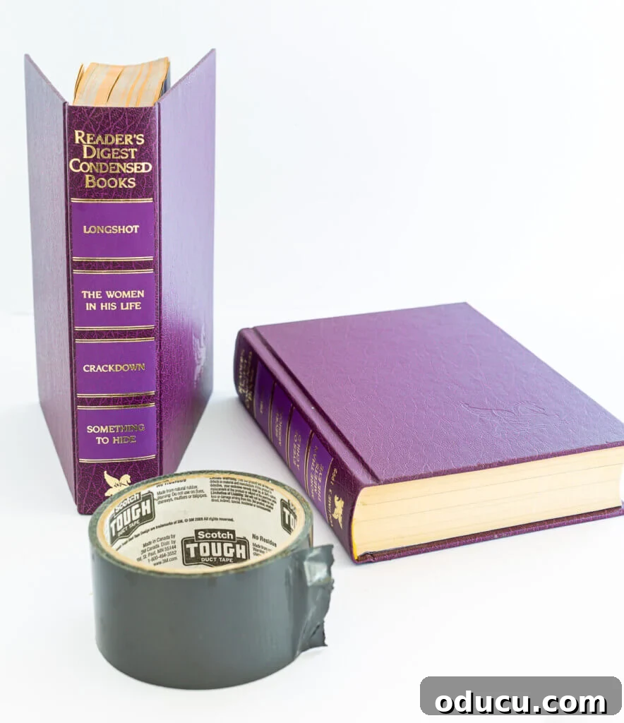 Literary Planters: Crafting Covers from Old Books 7 Essential supplies laid out for crafting a stylish planter or vase cover from two old books.