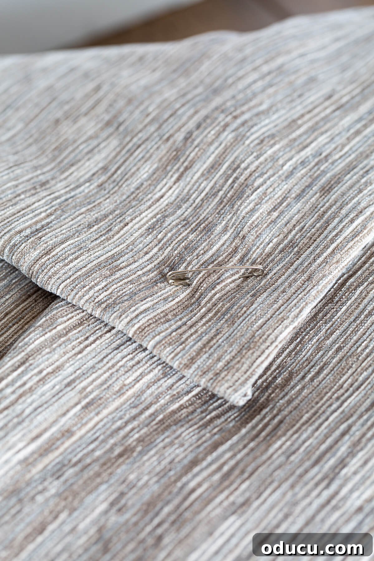 close up of safety pin closure on pillow