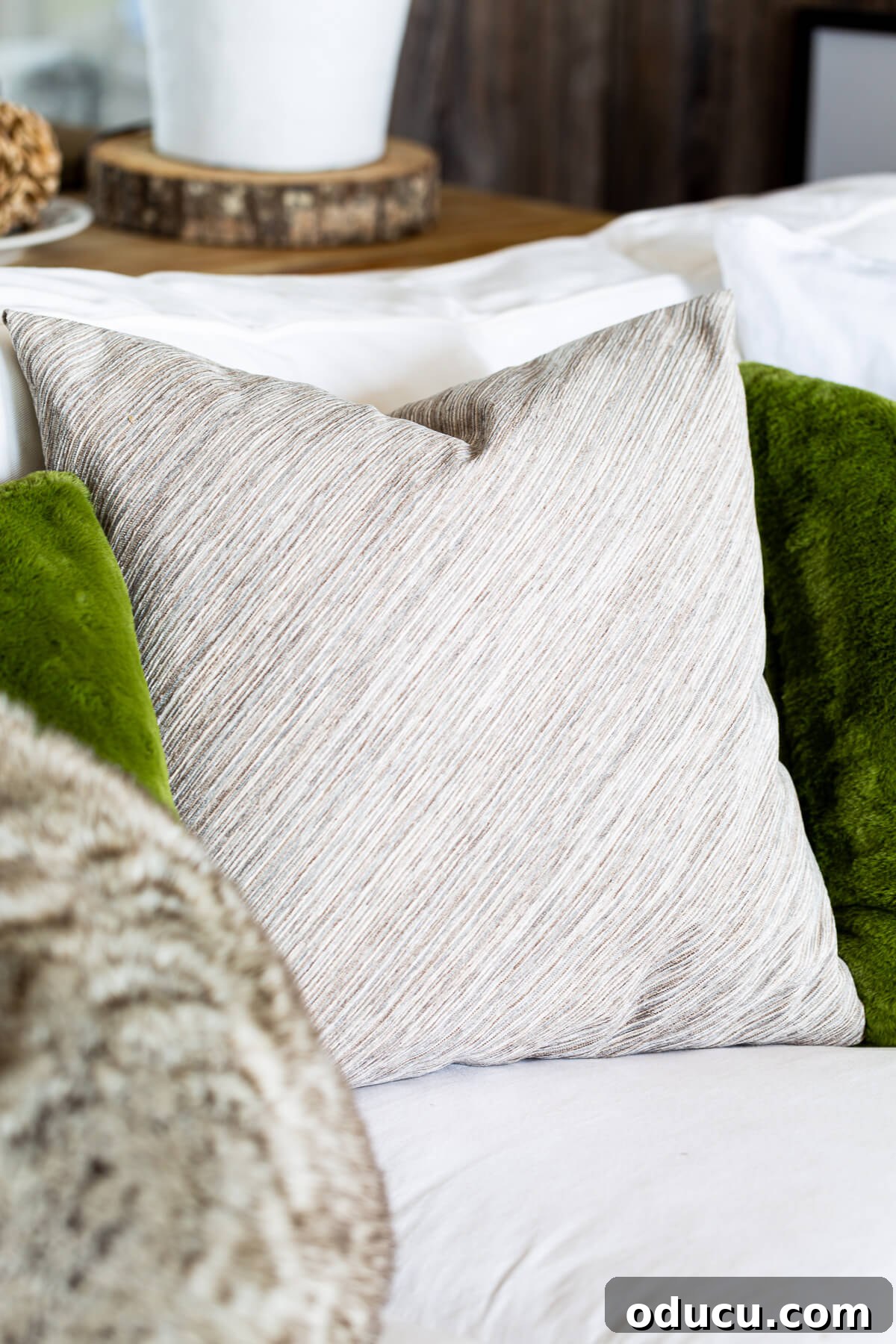 Plain side of no zipper pillow cover on a sofa.