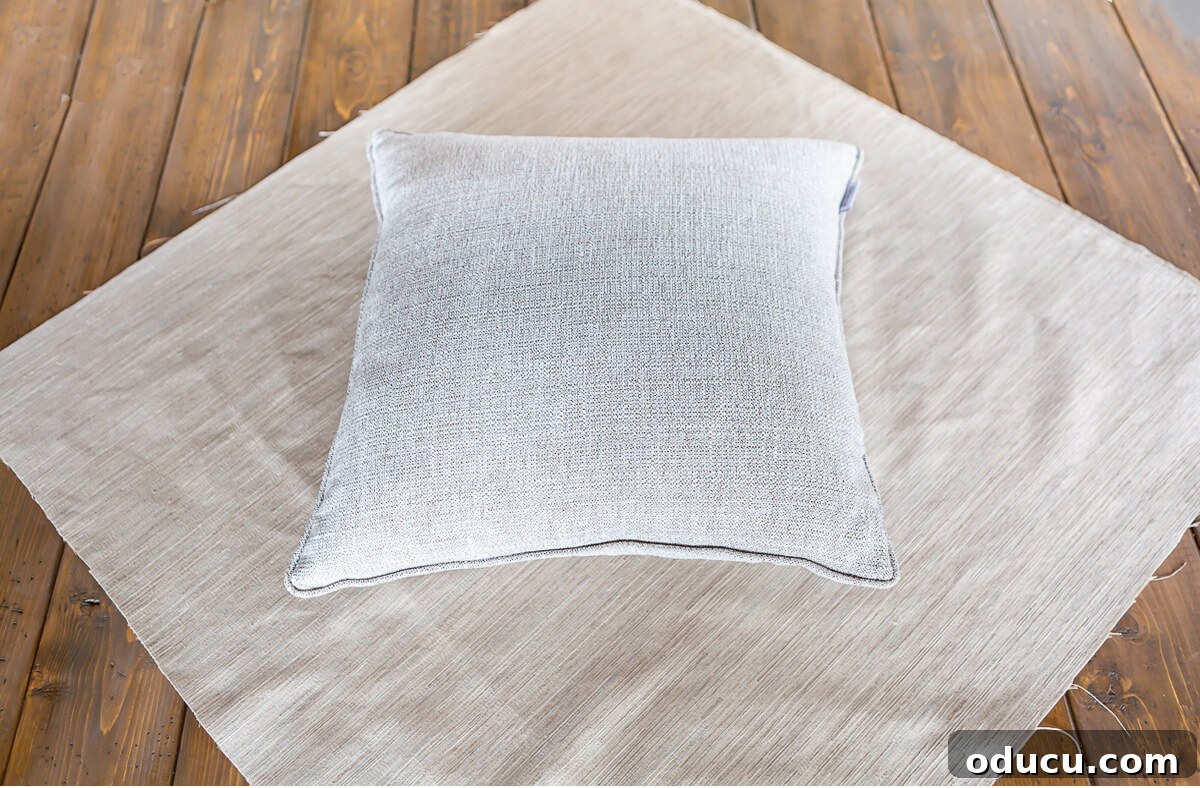 Pillow insert on a square of fabric.