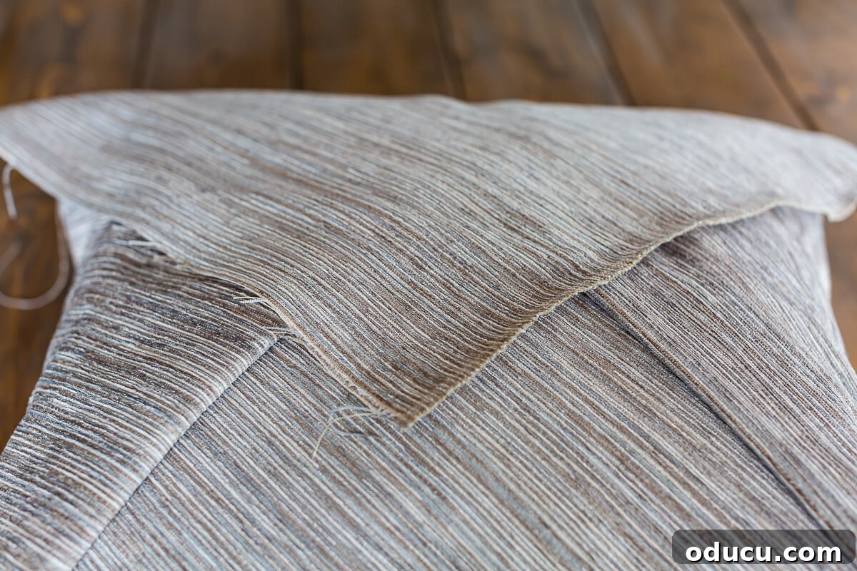 How to fold fabric over a pillow insert to make a decorative pillow.